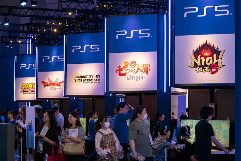 Visitantes pasan frente al estand de PlayStation, de Sony, durante la jornada previa de la feria anual Tokyo Game Show, en el centro de convenciones Makuhari Messe, en la ciudad de Chiba, prefectura de Chiba, el 25 de septiembre de 2025.