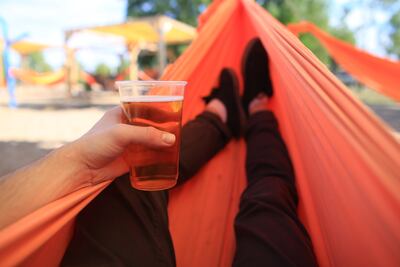 Un hombre disfruta de una cerveza en una hamaca paraguaya.
