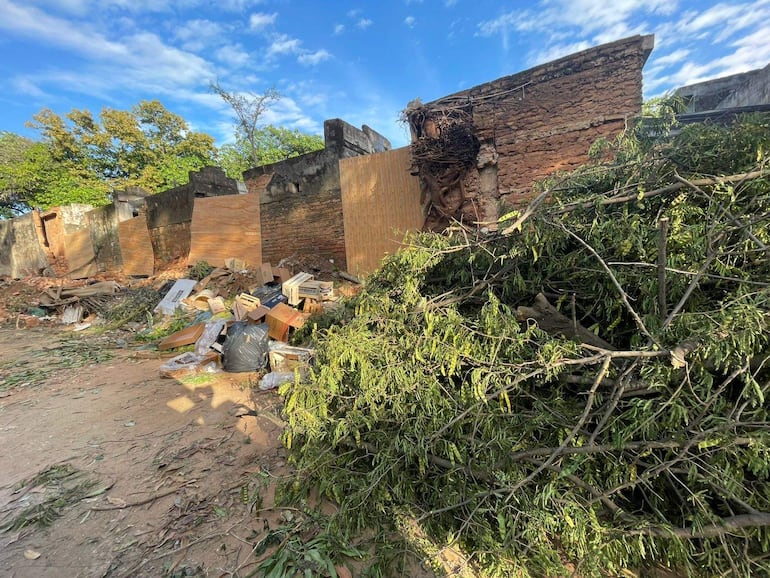 Paisaje urbano desordenado con basura y escombros, sin personas visibles ni elementos distintivos.