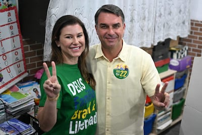 Flavio Bolsonaro, senador de derecha y candidato presidencial por el Partido Liberal (PL) de Brasil, y su esposa Fernanda Bolsonaro hacen el gesto de la "V" de la victoria en un centro de votación durante las elecciones presidenciales en Río de Janeiro, Brasil, el 4 de octubre de 2026. Los brasileños acuden a las urnas profundamente polarizados en una primera vuelta presidencial de resultado incierto y bajo la sombra del presidente estadounidense Donald Trump, quien ha respaldado a candidatos conservadores en recientes elecciones en América Latina.