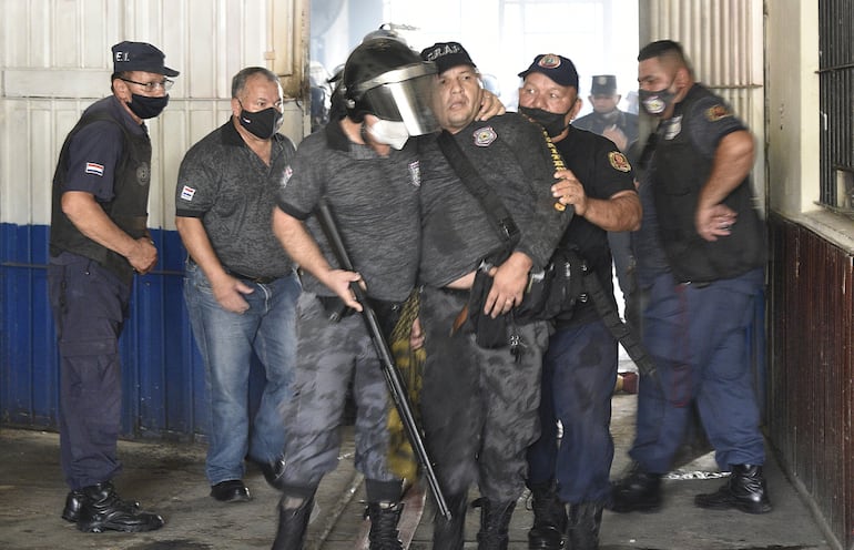 Uno de los 18 guardiacárceles deja la zona de las celdas, tras ser liberado después de estar 5 horas como rehén con sus colegas.