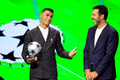 Portugal's national team player and Saudi Al-Nassr's forward Cristiano Ronaldo who is awarded the All-Time Goalscorer Award in the UEFA Champions League (L) and Italy's former goalkeeper Gianluigi Buffon who awarded the 2024 UEFA President's Award pose ojn stage during the ceremony of the draw for the group stage of the 2024-2025 UEFA Champions League football tournament, at the Grimaldi Forum in Monaco on August 29, 2024. (Photo by Valery HACHE / AFP)