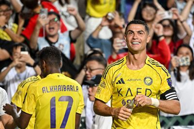 Al-Nassr's Cristiano Ronaldo (R) celebrates after scoring a goal during the Saudi Super Cup final football match between Al-Nassr and Al-Ahli at the Hong Kong Stadium in Hong Kong on August 23, 2025. (Photo by Wun Suen / AFP)