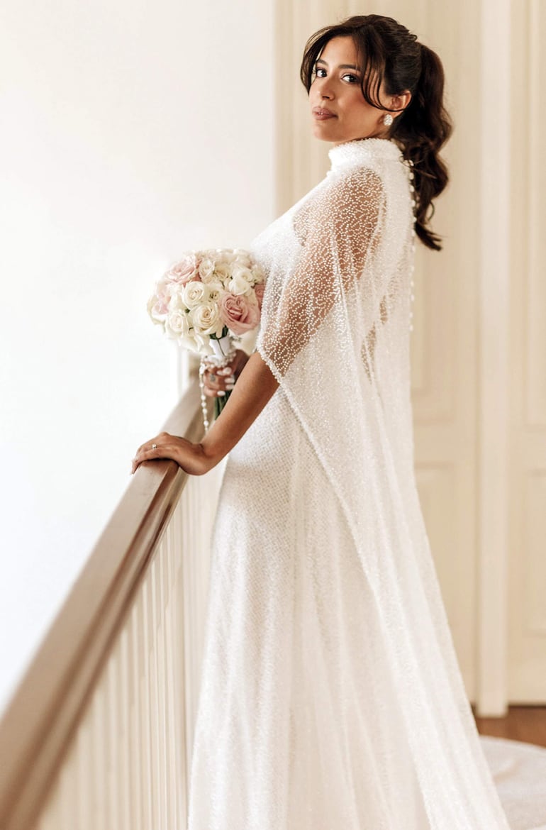 La novia lució delicada y elegante con un vestido diseñado por Nicole Burkholder y portó un ramo de rosas armado por Karen Dalles.