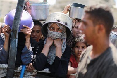 Varias personas intentan conseguir alimentos en un punto de entrega de ayuda humanitaria cerca de la Ciudad de Gaza, el pasado jueves.