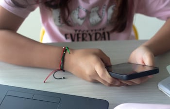 Una niña manipula un teléfono celular