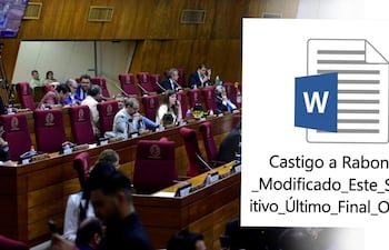 Hombre en saco claro habla en recinto legislativo, mientras otros diputados lo escuchan atentos y consultan sus móviles.