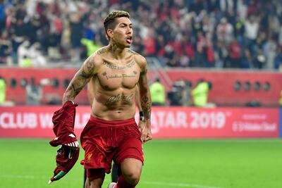 Liverpool's Brazilian midfielder Roberto Firmino celebrates after scoring during the 2019 FIFA Club World Cup Final football match between England's Liverpool and Brazil's Flamengo at the Khalifa International Stadium in the Qatari capital Doha on December 21, 2019. (Photo by Giuseppe CACACE / AFP)