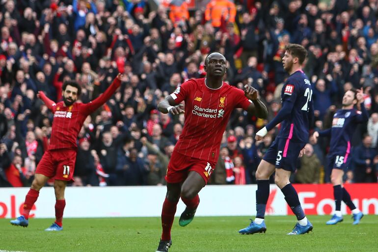 Liverpool's Senegalese striker Sadio Mane celebrates scoring his team's second goal during the English Premier League football match between Liverpool and Bournemouth at Anfield in Liverpool, north west England on March 7, 2020. (Photo by GEOFF CADDICK / AFP) / RESTRICTED TO EDITORIAL USE. No use with unauthorized audio, video, data, fixture lists, club/league logos or 'live' services. Online in-match use limited to 120 images. An additional 40 images may be used in extra time. No video emulation. Social media in-match use limited to 120 images. An additional 40 images may be used in extra time. No use in betting publications, games or single club/league/player publications. / 