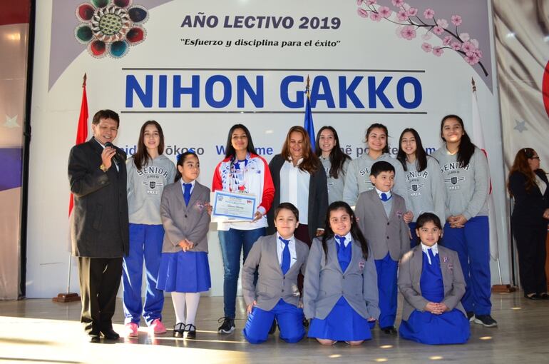 Tatiana Benítez posando con estudiantes y directivos del colegio.