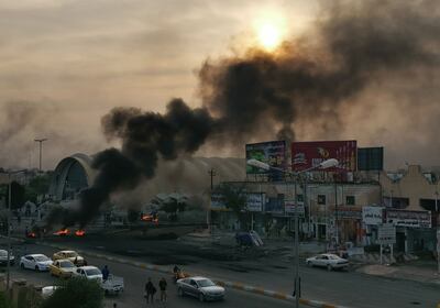 Columnas de humo de una barricada en llamas en una avenida de la ciudad de Nasiriya, Irak.