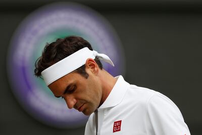 (FILES) In this file photograph taken on July 14, 2019, Switzerland's Roger Federer reacts after a point against Serbia's Novak Djokovic during their men's singles final on day thirteen of the 2019 Wimbledon Championships at The All England Lawn Tennis Club in Wimbledon, southwest London. - Roger Federer had two Wimbledon championship points on his own serve to beat Novak Djokovic and win his 21st Grand Slam title. That would have taken him six clear of the Serbian on the all-time list and three clear of Rafael Nadal at the time. Instead, he faltered. Djokovic, in a match lasting a shade under five hours, won his 16th Grand Slam and two months later Nadal won his 19th. "It's such an incredible opportunity missed," said the Swiss veteran, now 38 and who must fear his days as the all-time leader on the list are numbered. (Photo by Adrian DENNIS / POOL / AFP) / RESTRICTED TO EDITORIAL USE