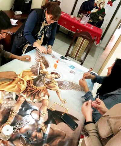 Los artistas dan los últimos retoques a la imagen de San Miguel.