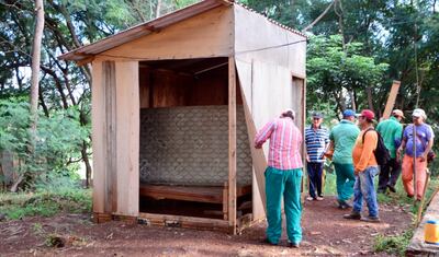 Funcionarios de Aseo Urbano proceden a desmantelar una de las precarias viviendas.
