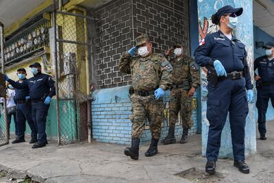 Miembros del Servicio Nacional de Fronteras de Panamá (C) y la Policía ayudan a voluntarios del "Plan de Solidaridad de Panamá" durante la entrega de ayuda alimentaria a familias de bajos ingresos durante la pandemia del nuevo coronavirus, COVID-19, en el barrio El Chorrillo en la Ciudad de Panamá el 1 de abril de 2020. - La Organización Mundial de la Salud dijo el miércoles que estaba preocupada por la reciente "escalada rápida" y la propagación mundial de la nueva pandemia de coronavirus. (Foto por Luis ACOSTA / AFP)