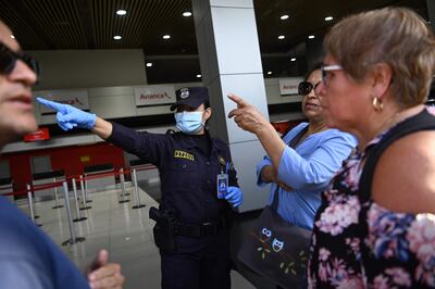 Passengers remain stranded at San Oscar Romero International Airport in San Luis Talpa, El Salvador, on March 16, 2020. - El Salvador's President Nayib Bukele said on Tuesday that San Oscar Romero International Airport will close for commercial flights and remain open only for humanitarian traffic and cargo, as a preventive measure against the spread of the new coronavirus, COVID-19. (Photo by MARVIN RECINOS / AFP)