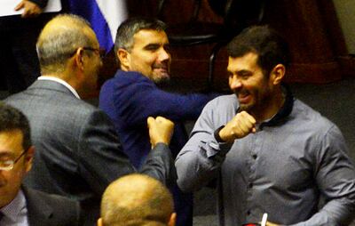 Diputados ensayan nuevos tipos de saludos sin contacto de manos ante el coronavirus.