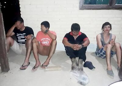 Los uniformados esposados junto a los otros dos detenidos.