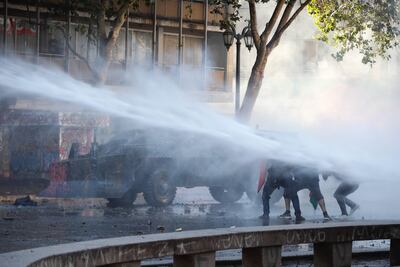 Manifestantes y Carabineros se enfrentan este martes en la céntrica Plaza Italia, rebautizado popularmente como "Plaza Dignidad", durante una nueva jornada de protestas en Santiago (Chile).