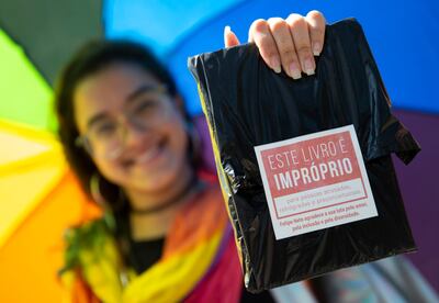 Una mujer muestra un libro de temática LGBT distribuidos de forma gratuita por el "youtuber" Felipe Neto en la Bienal de Río de Janeiro.