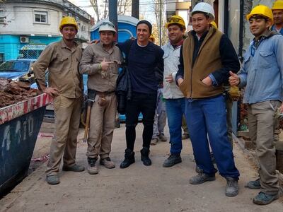 Adam Bareiro poso para una fotografía junto a trabajadores que estaban cerca del sanatorio donde realizó las pruebas médicas.