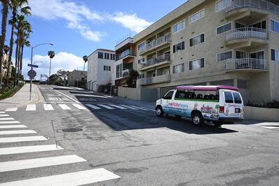 Adam Duford, owner of Surf City Tours, relocated his tour bus through an empty street near the beach in Santa Monica, California. as the coronavirus pandemic forced his normal tour bus business to a halt, March 23, 2020. - In an attempt to keep his business alive Duford has started giving online "virtual tours" .