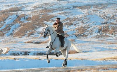 En esta foto no fechada distribuida por la Agencia Central de Noticias de Corea del Norte se ve al líder de ese país Kim Jong Un cabalgando sobre un caballo blanco en las montañas.