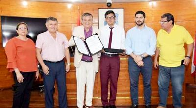 El deportista Óscar Chena González (de corbata) recibe el premio “Ápe Aime” por parte de las autoridades.