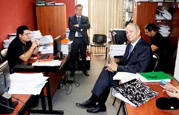 Mario Ferreiro (d) a punto de iniciar su declaración, acompañado de su abogado Guillermo Ferreiro (de pie). El exintendente alega que no hay elementos suficientes para que le imputen.