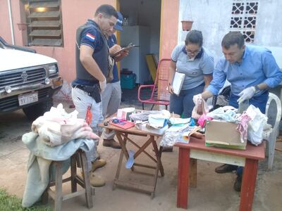 Los intervinientes toman nota de los elementos incautados en la casa del supuesto abusador.