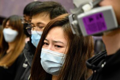Winnie Yu (C), chairwoman of the Hospital Authority Employees Alliance (HAEA), speaks during a strike at the Hospital Authority building in Hong Kong on February 7, 2020, calling for the government to close its border with mainland China to contain the new coronavirus epidemic. - Hong Kong on February 7 said it will deploy an army of volunteers to bolster plans to forcibly quarantine all arrivals from mainland China, warning that anyone caught breaching the new rules faces up to six months prison. (Photo by Philip FONG / AFP)