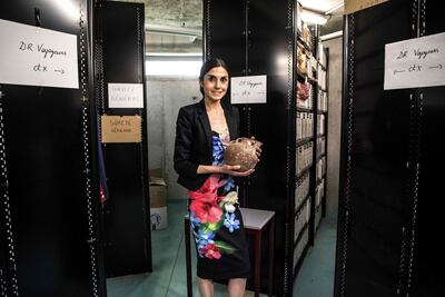 (FILES) In this file photo taken on June 24, 2019 French Customs official Anne-Sophie Vitoux holds an artifact before handing it over to a Pakistani embassy official at the Customs department at Roissy airport outside Paris. (Photo by Christophe ARCHAMBAULT / AFP)