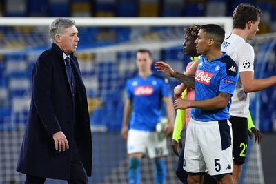 Napoli's Italian head coach Carlo Ancelotti (L) goes to congratulate Napoli's Brazilian defender Allan (R) at the end of the UEFA Champions League Group E football match Napoli vs Genk on December 10, 2019 at the San Paolo stadium in Naples. (Photo by Tiziana FABI / AFP)