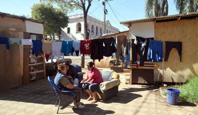 Tres mujeres  toman mate luego de lavar ropa en la Plaza de Armas, donde fueron reubicadas por la crecida del río. Esta semana podrían retornar a sus hogares.