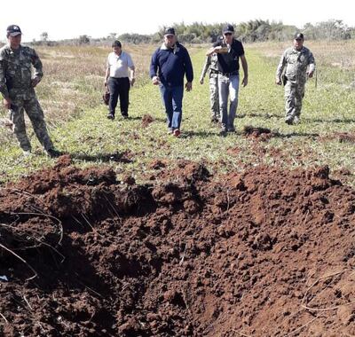 Autoridades verifican uno de los hoyos provocados para impedir el uso de la pista clandestina.