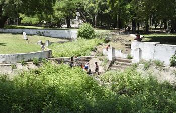 Niños indígenas lavan ropa y juegan en la laguna represada del Parque Caballero, que se convirtió en un megacriadero de dengue, ya que en el lugar existen varios recipientes de plástico con agua.