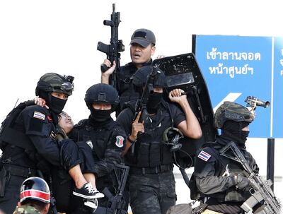 Soldados evacúan a una persona herida en el sitio del tiroteo en un centro comercial en Nakhon Ratchasima, Tailandia.