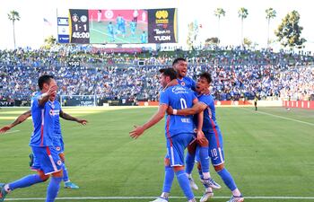 Santiago Giménez (N° 9), celebra con Juan Escobar y Ángel Romero (N° 10) uno de los goles del Cruz Azul ante Atlas.