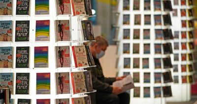 Un hombre lee durante la Feria del Libro de Fráncfort, la mayor del mundo, que este miércoles abrió sus puertas al público en una edición todavía marcada por la pandemia después de que el año anterior el coronavirus obligara a que la muestra solo pudiera realizarse en formato digital.