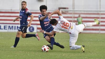Ante la mirada de  Edgardo Orzusa (autor del gol albo), el capitán de Nacional, Cristian Riveros, disputa el balón con Ramón Sosa, que marcó el tanto de  River Plate.