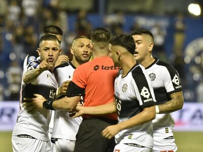 Los jugadores de Olimpia, incluyendo Derlis González, quien señala, protestan por la amarilla que Derlis López mostró al atacante por un festejo.