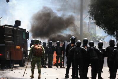 Policías antimotines se enfrentan a manifestantes hoy, en las calles de Quito (Ecuador).