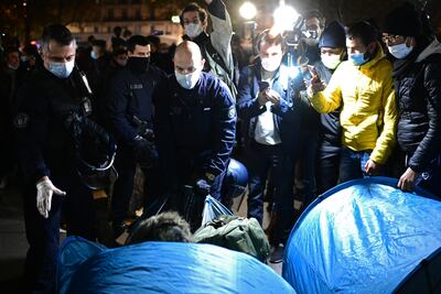Gendarmes franceses desmantelan un campamento de migrantes en la Plaza de la República de París, Francia.