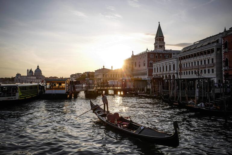 Una góndola navega por el Gran Canal, con el Palazzo Ducale de fondo en Venecia, Italia.