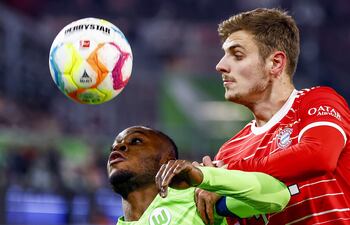 Ridle Baku (i), del Wolfsburgo, disputa el balón con Josip Stanisic, del Bayern Munich,, durante el cotejo jugado ayer.