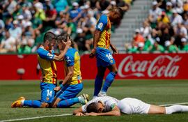El defensa y capitán del Valencia FC, José Luis Gayá (i) y el delantero uruguayo Edinson Cavani (c) Gayá celebran el gol en propia puerta del defensa del Elche, Gonzalo Verdú (d) durante el encuentro correspondiente a la treintava jornada de LaLiga entre el Elche y el Valencia este domingo en el estadio Martínez Valero de Elche.