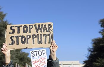 Un manifestante sostiene un cartel que dice "Stop War Stop Putin" mientras protesta contra la operación militar masiva de Rusia contra Ucrania durante una manifestación en la sede de las Naciones Unidas en Ginebra.