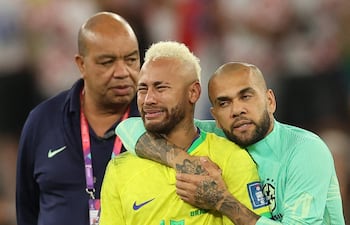 Dani Alves trata de consolar a Neymar, quien llora la eliminación de Brasil en cuartos de final del Mundial de Qatar 2022.