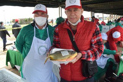 Los productores Neri Pereira y Antonio Sapper, presidente y vive, respectivamente, de la Asociación de piscicultores de Edelira, muestran una variedad de pacu criado en estanque.