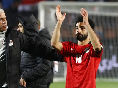 Egypt's national team manager Wael Gomaa (L) looks on as forward Mohamed Salah (R) reacts after their team won the 2022 Qatar World Cup African Qualifiers football match between Egypt and Senegal at Cairo International Stadium in the Egyptian capital on March 25, 2022. (Photo by Khaled DESOUKI / AFP)